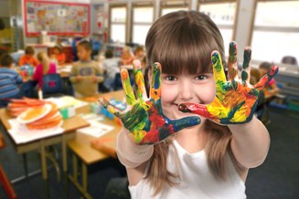 School Age Child Painting With Her Hands In Class
